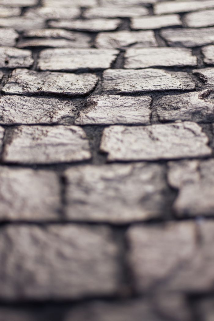 Detailed view of textured cobblestones in a street, capturing urban charm.