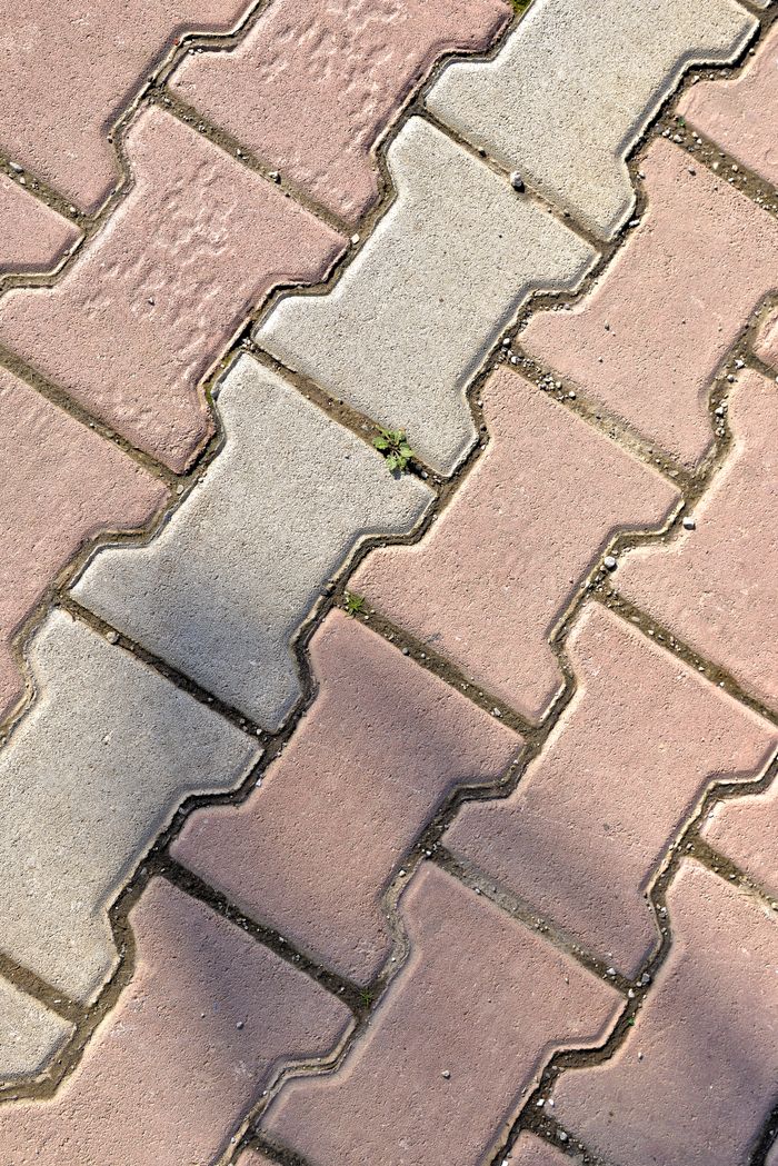 Close-up of interlocking brick pavement casting shadows in Fès, Morocco.